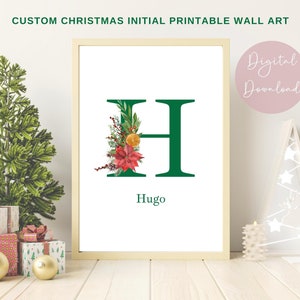 May include: Printable Christmas wall art featuring the letter H decorated with green, red, and orange floral elements. The name Hugo is written below the letter.