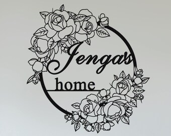 May include: Black metal wall decor with a floral wreath and the text "Jengas home".