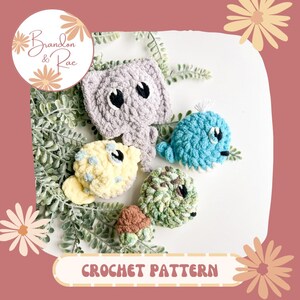 May include: Crochet pattern for a set of four amigurumi toys: a gray elephant, a blue whale, a yellow fish, and a green turtle. The pattern is titled "Brandon & Rae Crochet Pattern".