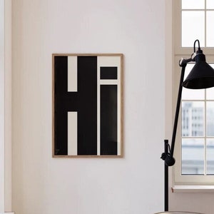 Black text with the word “Hi” in a simple, bold font on a beige background. Decorating with typography prints is the perfect way to create a unique style and add a personal touch to your home.