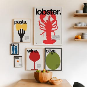 May include: A set of six minimalist posters featuring illustrations of various foods, including a lobster, pasta, fish, wine, olive, and an egg. The posters are framed in black and white frames and are hung on a white wall. The posters all share a similar style, with bold black text and simple illustrations.