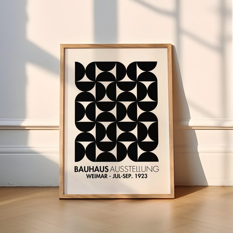 Bauhaus Exhibition inspired Poster 1923 with black text with the words “BAUHAUS AUSSTELLUNG WEIMAR JUL – SEP 1923” on a beige background. Features a Bauhaus inspired black geometric illustration.