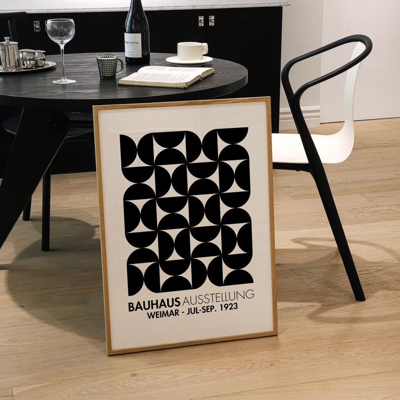 May include: A framed black and white geometric print with the text "Bauhaus Ausstellung Weimar - Jul-Sep. 1923".
