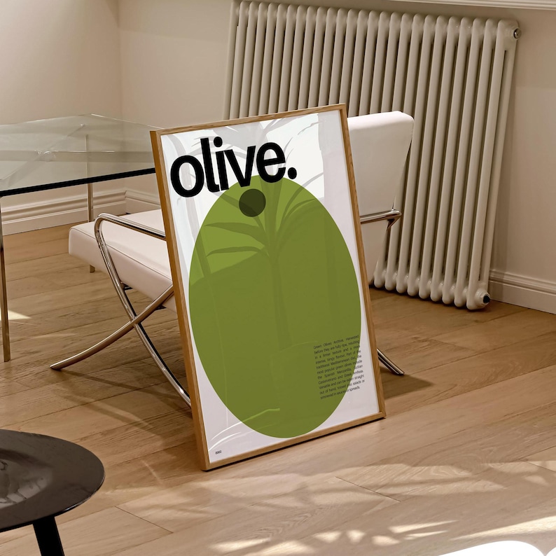 May include: A framed poster featuring a green olive illustration and the word "olive." in black text. The poster has a white background and a wooden frame.
