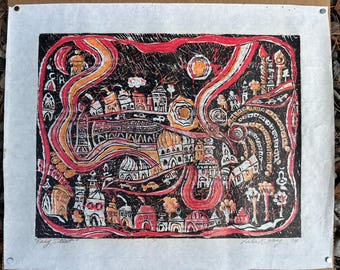 May include: An abstract print titled "Easy Street" featuring a cityscape in red, orange, and white against a black background. The artwork includes buildings, arches, and swirling lines, with a sun-like shape. The print is on textured paper.