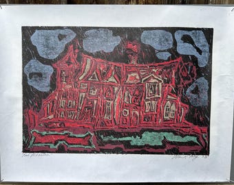 May include: A red and black print of a building with a unique architectural style, featuring multiple windows and gabled roofs. The artwork includes blue cloud shapes against a dark background. Signed by the artist, with the year 85.