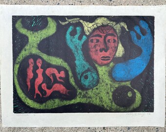 May include: Abstract art print featuring a red face with blue and green shapes on a black background. The print includes red figures within a green shape. The artwork is signed and dated.
