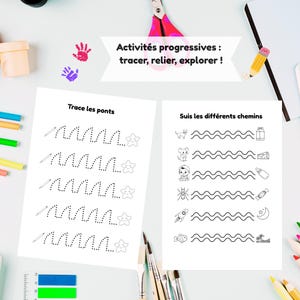 May include: Two white activity sheets with black line drawings and text. One sheet has dotted lines to trace and the text "Trace les ponts". The other sheet has wavy lines with images and the text "Suis les diff&eacute;rents chemins". Pink scissors and colourful pencils are also visible.