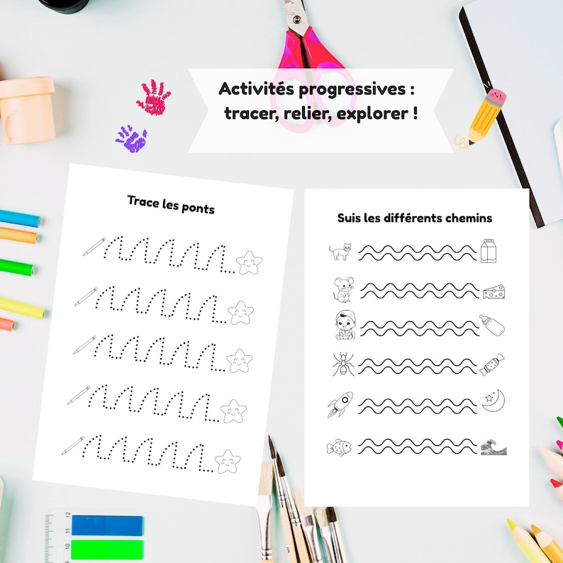 May include: Two white activity sheets with black line drawings and text. One sheet has dotted lines to trace and the text "Trace les ponts". The other sheet has wavy lines with images and the text "Suis les diff&eacute;rents chemins". Pink scissors and colourful pencils are also visible.