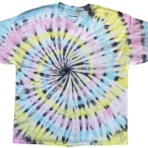 May include: A short-sleeved crew neck t-shirt featuring a spiral tie-dye pattern in pastel yellow, light blue, and soft pink, accented with bold black streaks radiating from the centre. The garment has a standard fit with a visible neck label.
