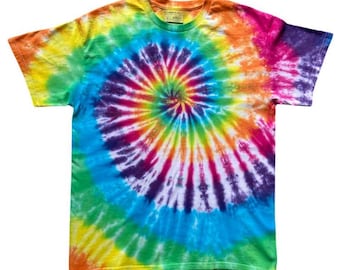 May include: A short-sleeved crew neck t-shirt featuring a vibrant multi-coloured tie-dye pattern. The design displays a prominent spiral motif radiating from the centre, incorporating shades of red, orange, yellow, green, blue, and purple throughout.