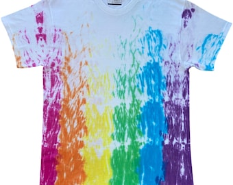 May include: A white short-sleeved t-shirt featuring a vertical rainbow tie-dye pattern. The design displays distinct bands of magenta, orange, yellow, green, blue, and purple colours that fade into the white fabric. A size L tag is visible at the neck.