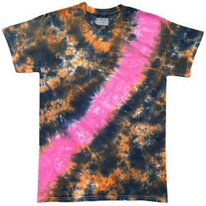 May include: A short-sleeved crew neck t-shirt featuring a tie-dye pattern with a diagonal stripe of bright pink running across a background of black and orange mottled colours. The shirt has a standard fit with visible stitching along the sleeves and hem.