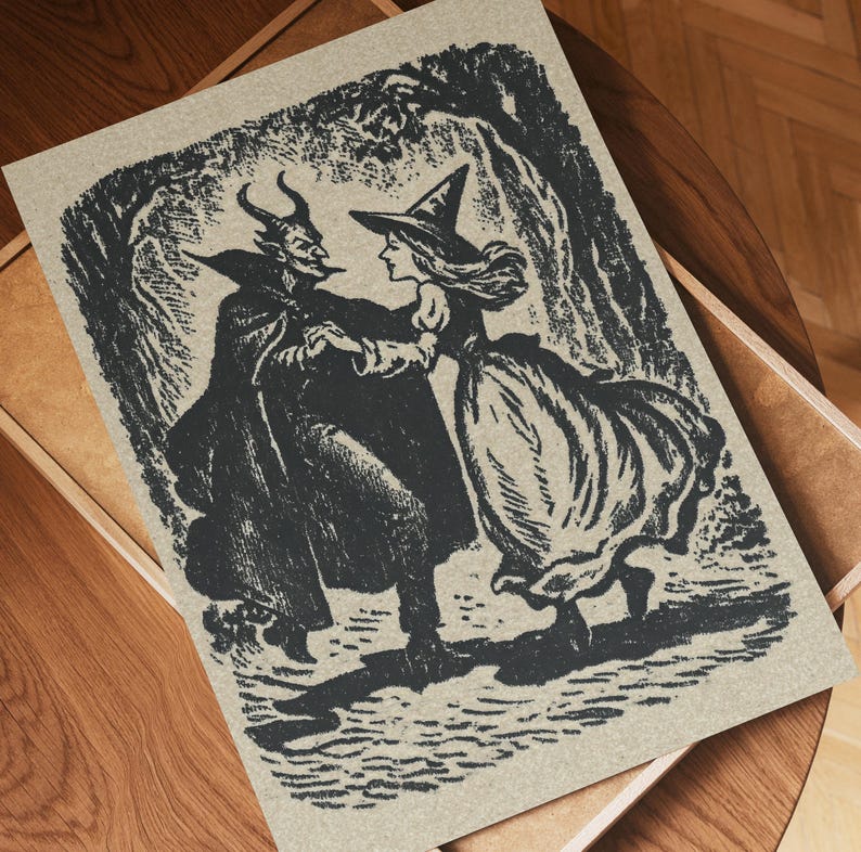 May include: A black and white illustration depicting a devil and a witch dancing in a forest. The devil is horned and cloaked, the witch wears a pointed hat and dress. The artwork is printed on a tan paper.