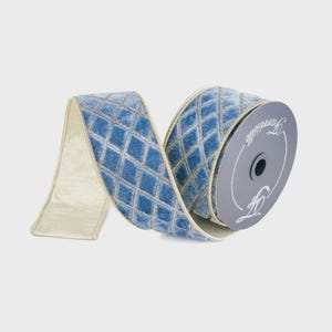 May include: A spool of light blue velvet ribbon featuring a gold diamond lattice pattern. The ribbon has a solid light blue velvet underside and is wound around a grey circular cardboard core with the brand name Farrisilk printed in white.
