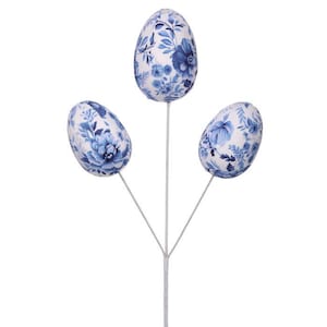 May include: Three decorative Easter egg stems. Each egg is oval-shaped and covered in a blue floral pattern on a white background. The eggs are attached to thin, white stems, creating a visually appealing arrangement.