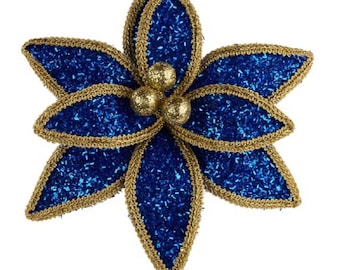 May include: A decorative poinsettia flower with blue glitter petals and gold trim. The center features three gold glitter balls. The flower is attached to a thin gold stem, perfect for holiday decor.
