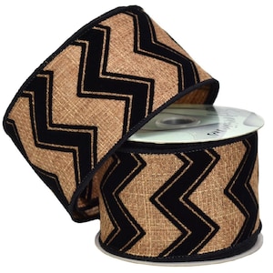 May include: A roll of decorative ribbon featuring a tan burlap-like texture with bold black chevron patterns. The ribbon has a black trim along the edges, adding a defined border to the design. The ribbon is ideal for crafting and gift wrapping.