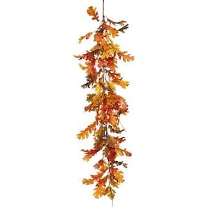 May include: A fall-themed garland featuring oak leaves in shades of orange, yellow, and brown. The leaves are arranged along a brown stem, creating a decorative accent for seasonal decor. The garland is ideal for adding a touch of autumn to any space.