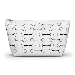 May include: White zippered makeup bag with a black and white repeating pattern of horse bits.