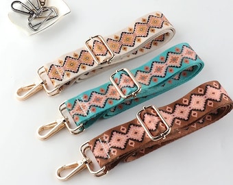 May include: Three patterned fabric straps with gold metal clasps. The straps are in beige, turquoise, and brown with a geometric design.