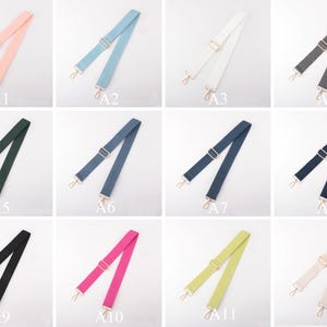 May include: A collection of adjustable bag straps in various colors, including pink, blue, white, gray, green, navy, black, fuchsia, yellow-green, and beige. Each strap has gold-colored metal hardware for attachment.