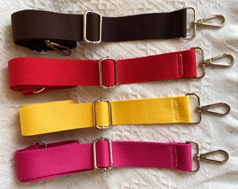 May include: Four adjustable straps in brown, red, yellow, and pink with silver metal clasps and swivel hooks.