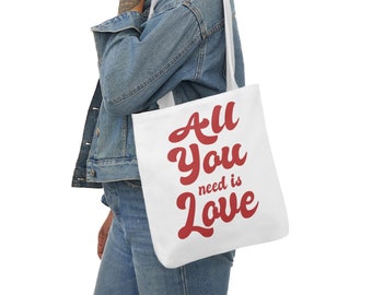 May include: A white tote bag with red text that reads "All you need is Love".