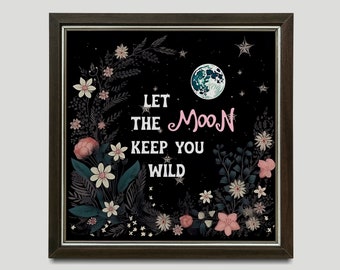 May include: A black framed print with a floral design and a moon. The text reads "Let the Moon keep you wild."