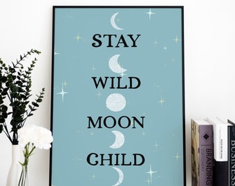 May include: A blue poster with white crescent moons and stars. The text on the poster reads "Stay Wild Moon Child."