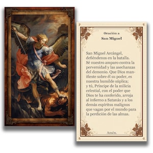 May include: A framed religious artwork showing Saint Michael the Archangel, with a sword, overcoming a demon. Beside it is a prayer card with Spanish text, including the title "Oración a San Miguel."