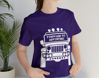 May include: A purple t-shirt featuring a white graphic of a jeep with the text "Forward to Adventure" on the windscreen.