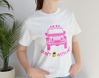 May include: White t-shirt with a pink jeep graphic and the text "Don't mess with me!"  A yellow rubber duck is in the middle of the text.