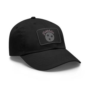 May include: Black baseball cap with a patch featuring the text "Franklin" and a star design.