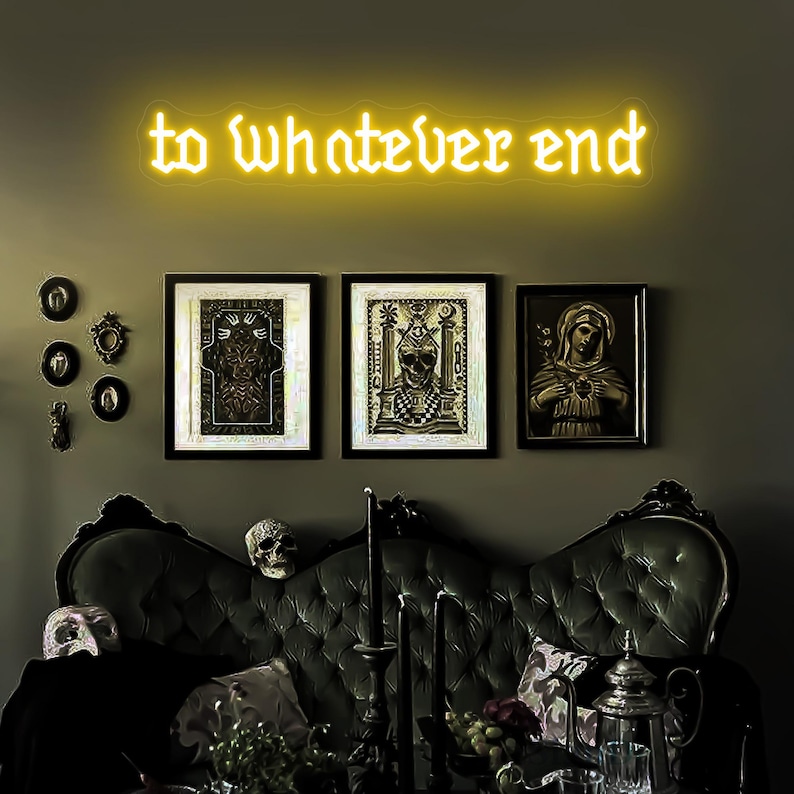 May include: A dark green velvet couch with a neon sign above it that reads "to whatever end". There are three framed pictures on the wall behind the couch, one of which depicts a woman in a long dress holding a heart.