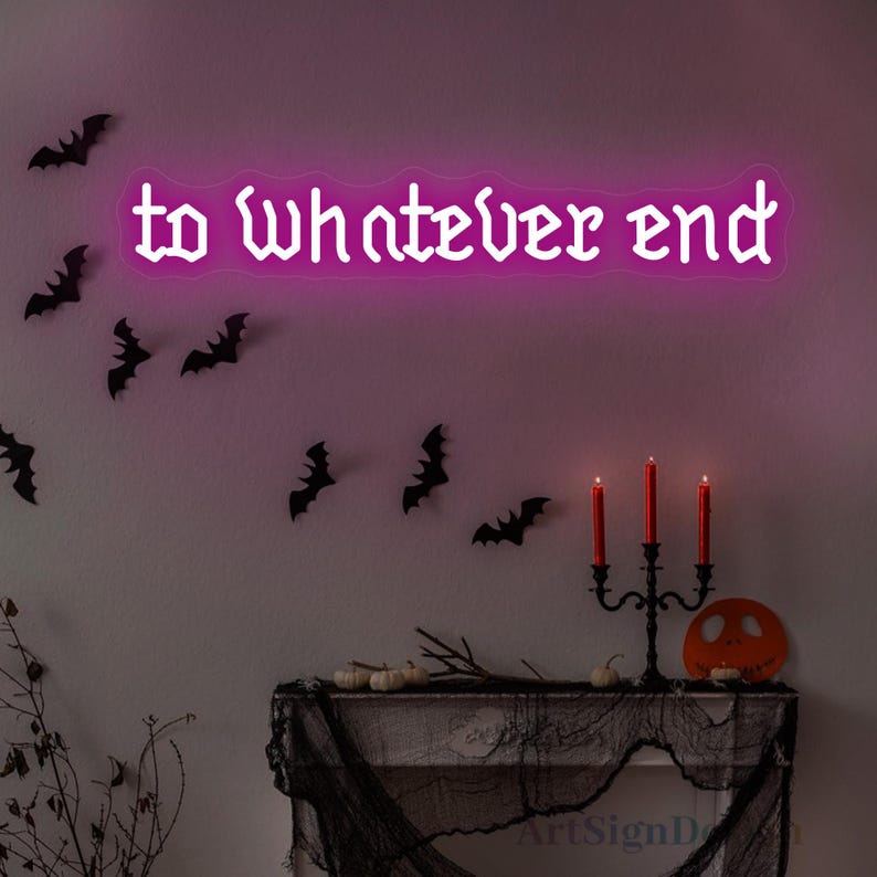 May include: Pink neon sign with the text "to whatever end" in a gothic font. The sign is hanging on a wall with black bats and a fireplace with candles below.
