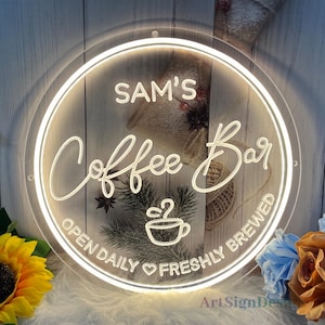 May include: White neon sign with the text "Sam's Coffee Bar Open Daily Freshly Brewed" and a coffee cup icon.
