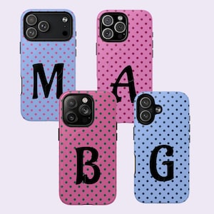 May include: Four phone cases with different designs. Two cases are light blue with black polka dots and large black letters, "M" and "G". The other two cases are pink with black polka dots and large black letters, "A" and "B".