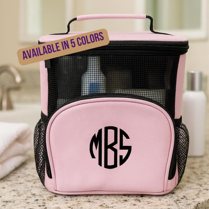 Personalized pink shower caddy with monogram styled on a bathroom counter—perfect for dorms, travel, and graduation gifts. Available in 5 colors.