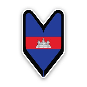 May include: A blue and red heart-shaped sticker featuring the flag of Cambodia. The flag depicts a white temple on a red band with blue on either side.