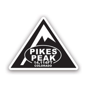 May include: Black and white sticker of a mountain peak with the text "PIKES PEAK 14,114FT COLORADO" in a white oval.