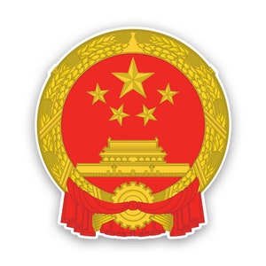 May include: A gold and red emblem with a five-pointed star and four smaller stars, a stylized building, and a gear in the center. The emblem is surrounded by a wreath of wheat.