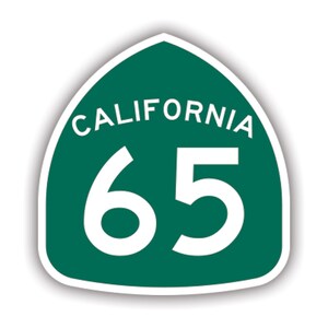 May include: A green and white California State Route 65 highway sign. The sign is shield-shaped with a white border and features the word "CALIFORNIA" in white text at the top and the number "65" in large white numerals.