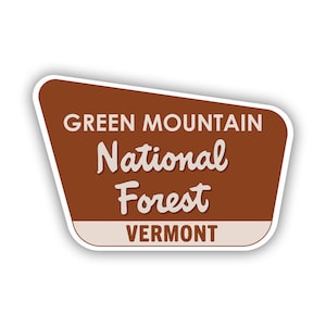 May include: A brown and white sign with the text "Green Mountain National Forest Vermont".