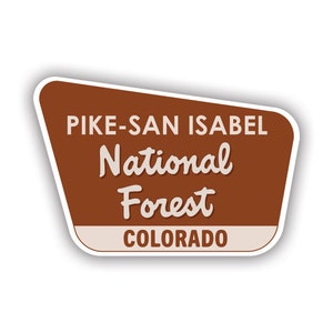 May include: A brown and white sign with the text "Pike-San Isabel National Forest Colorado".