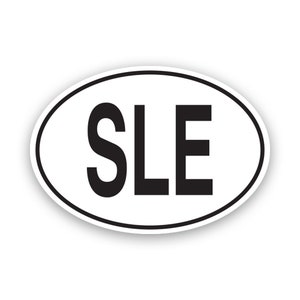 May include: White oval sticker with black text that reads "SLE".
