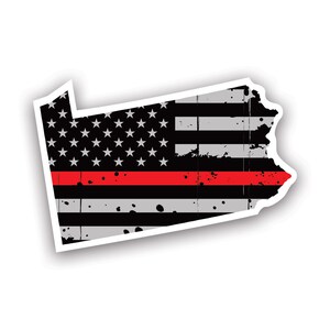 May include: A sticker in the shape of Pennsylvania, featuring a distressed American flag design with a red line. The flag has black and gray stripes, white stars, and a red stripe across the middle.