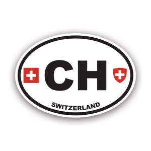 May include: White oval sticker with a black and white "CH" in the center. The letters are surrounded by a red Swiss cross on each side. The text "SWITZERLAND" is printed below the letters.