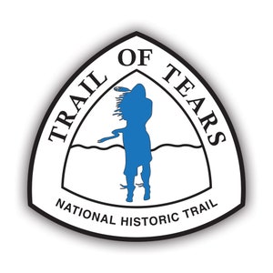May include: A white triangle with a black border and the text "Trail of Tears National Historic Trail". Inside the triangle is a blue silhouette of a person with long hair and a wavy line representing water.