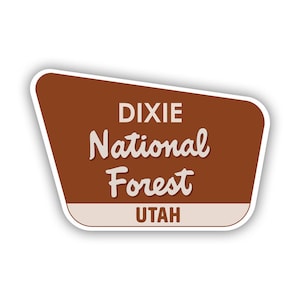 May include: A brown and white sign with the text "Dixie National Forest Utah" in a retro style font.
